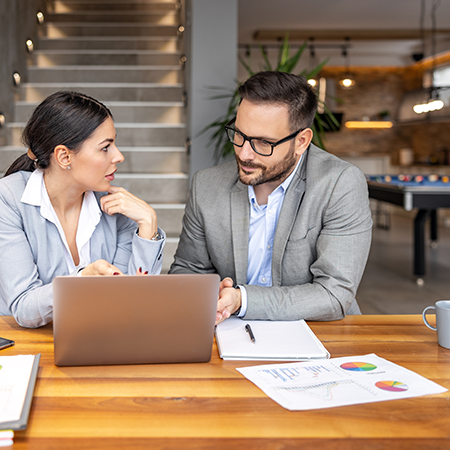 two coworkers at the office discuss about business strategy of new investments successful business 2255159219 450