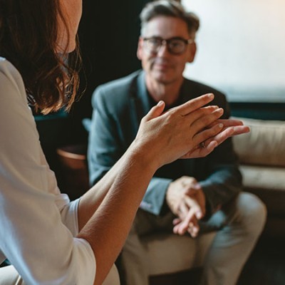 two business people discussing in office lounge businesswoman talking with a male colleague in 1702602871 (1)