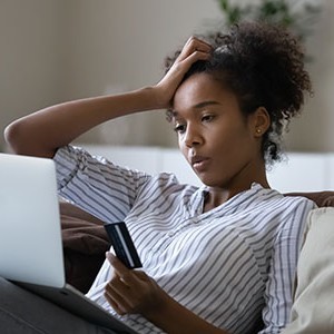 unhappy millennial african american woman distressed with problems paying online on laptop with 2025356384