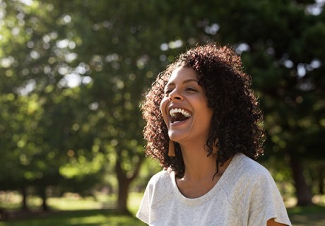 young woman curly hair laughing while 1687578475